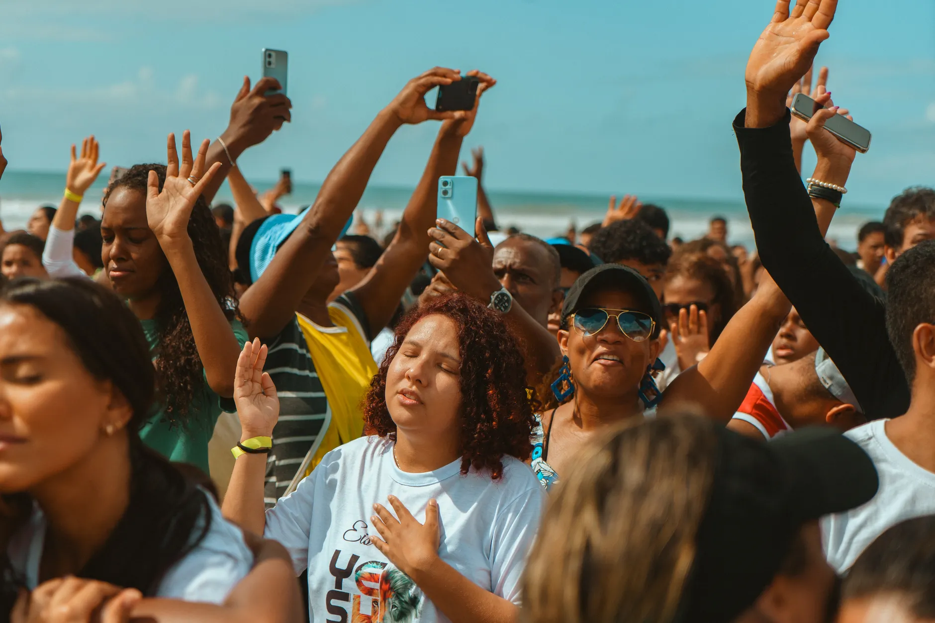 Concert crowd facing a brightly lit stage