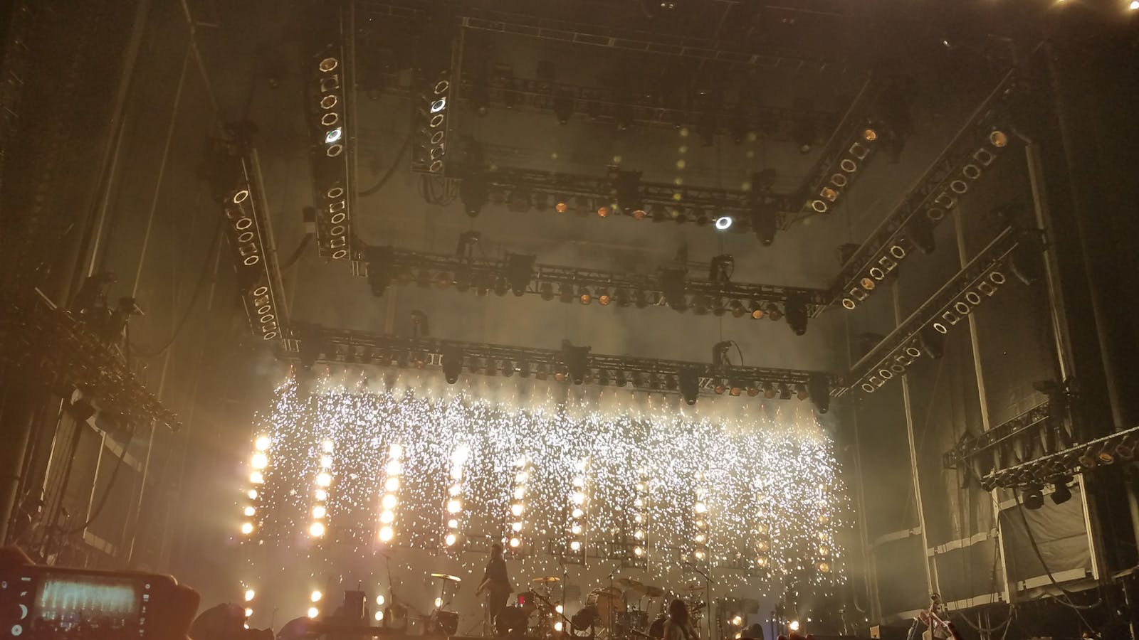 Packed live room under colorful stage lighting