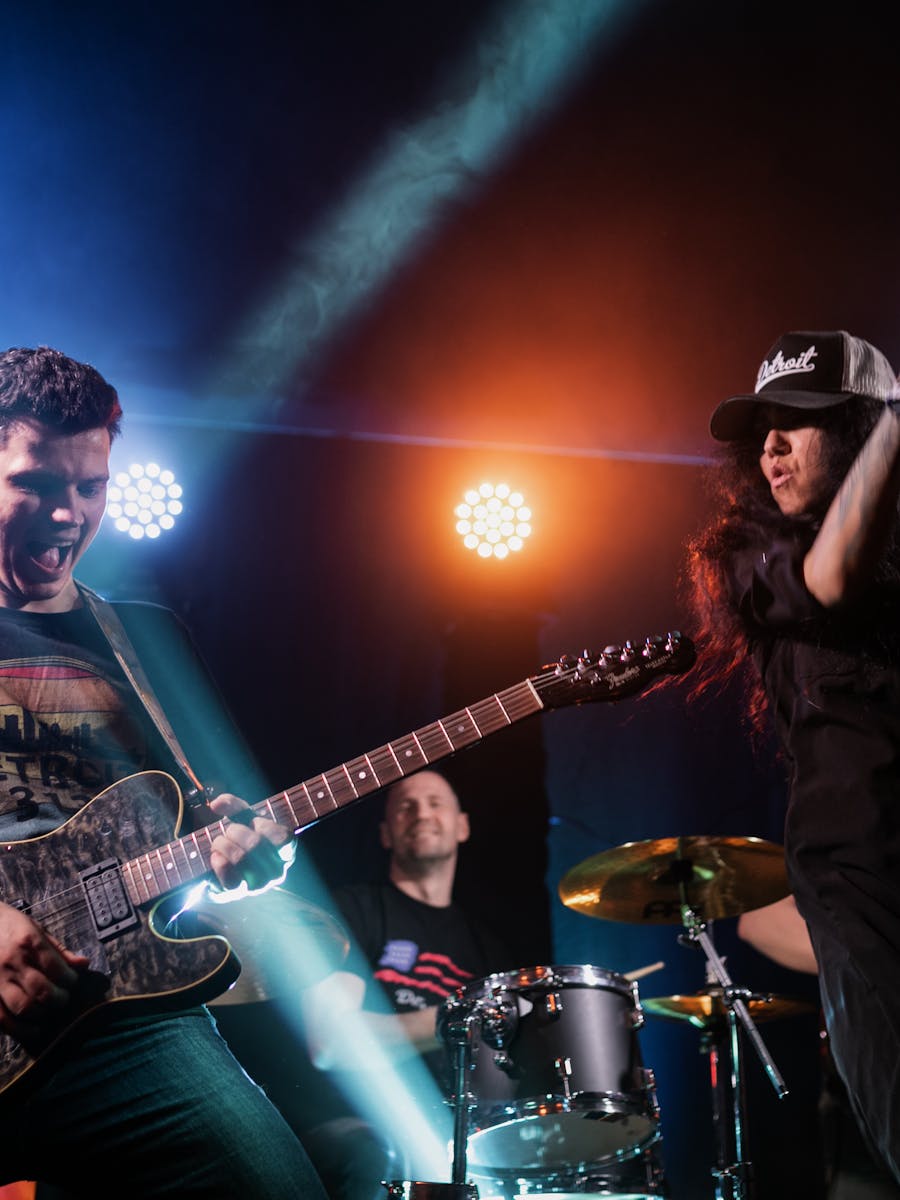 Musician playing electric guitar in a dark studio setting