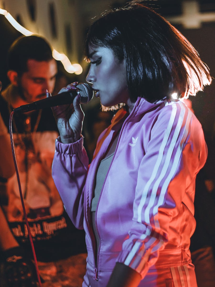 Performer holding a microphone on stage
