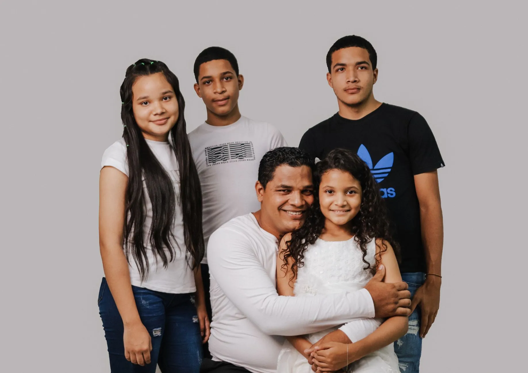 Family smiling together during an outdoor portrait session