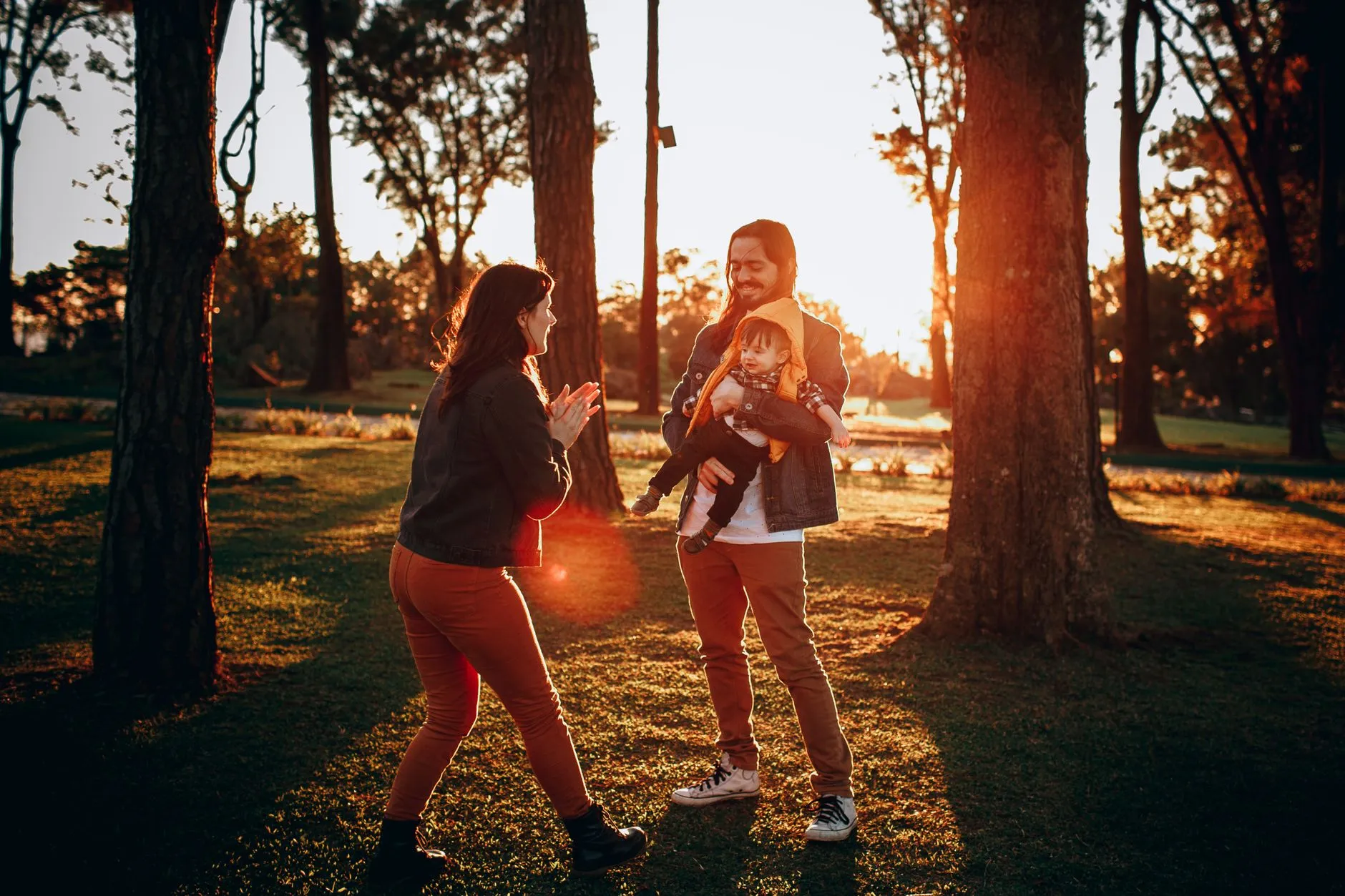 Family laughing together in soft natural light