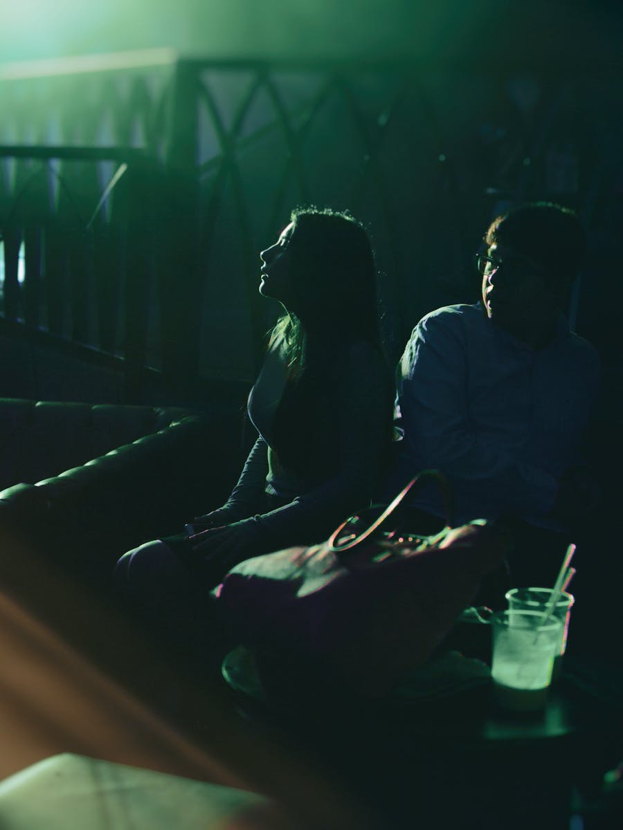 Crowd gathered around a nightlife table under club lights