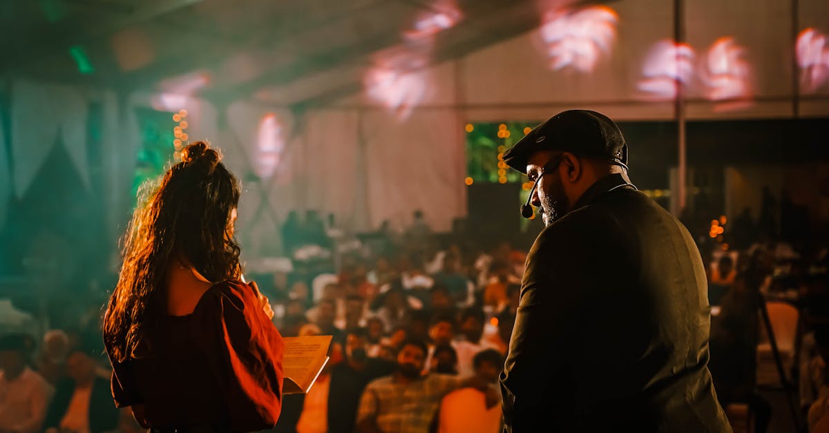Packed venue crowd under stage lights
